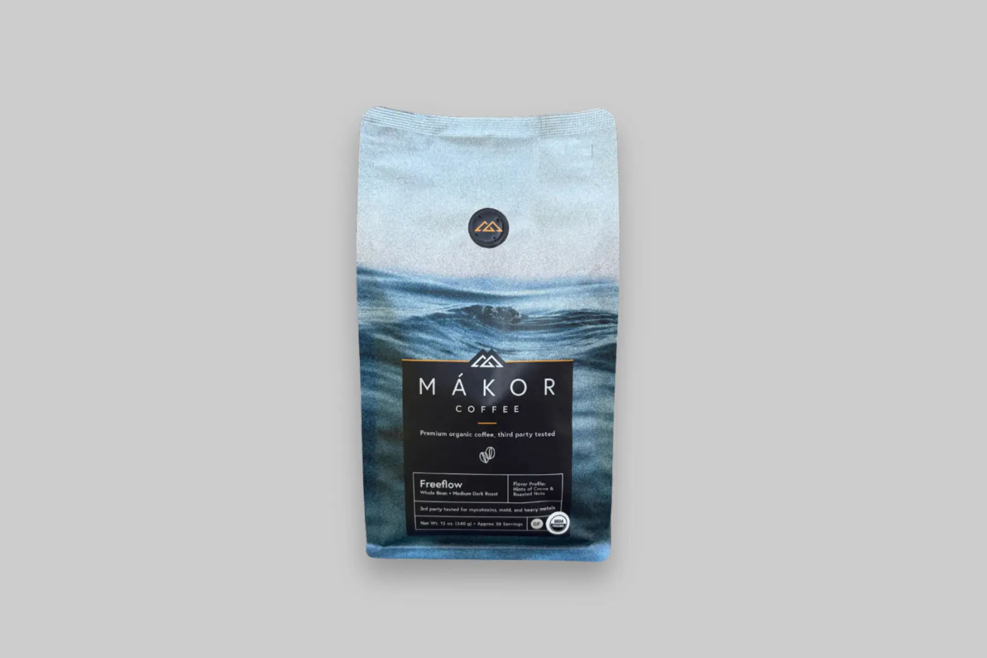 Bag of Mákor Freeflow organic whole bean coffee with a blue water design