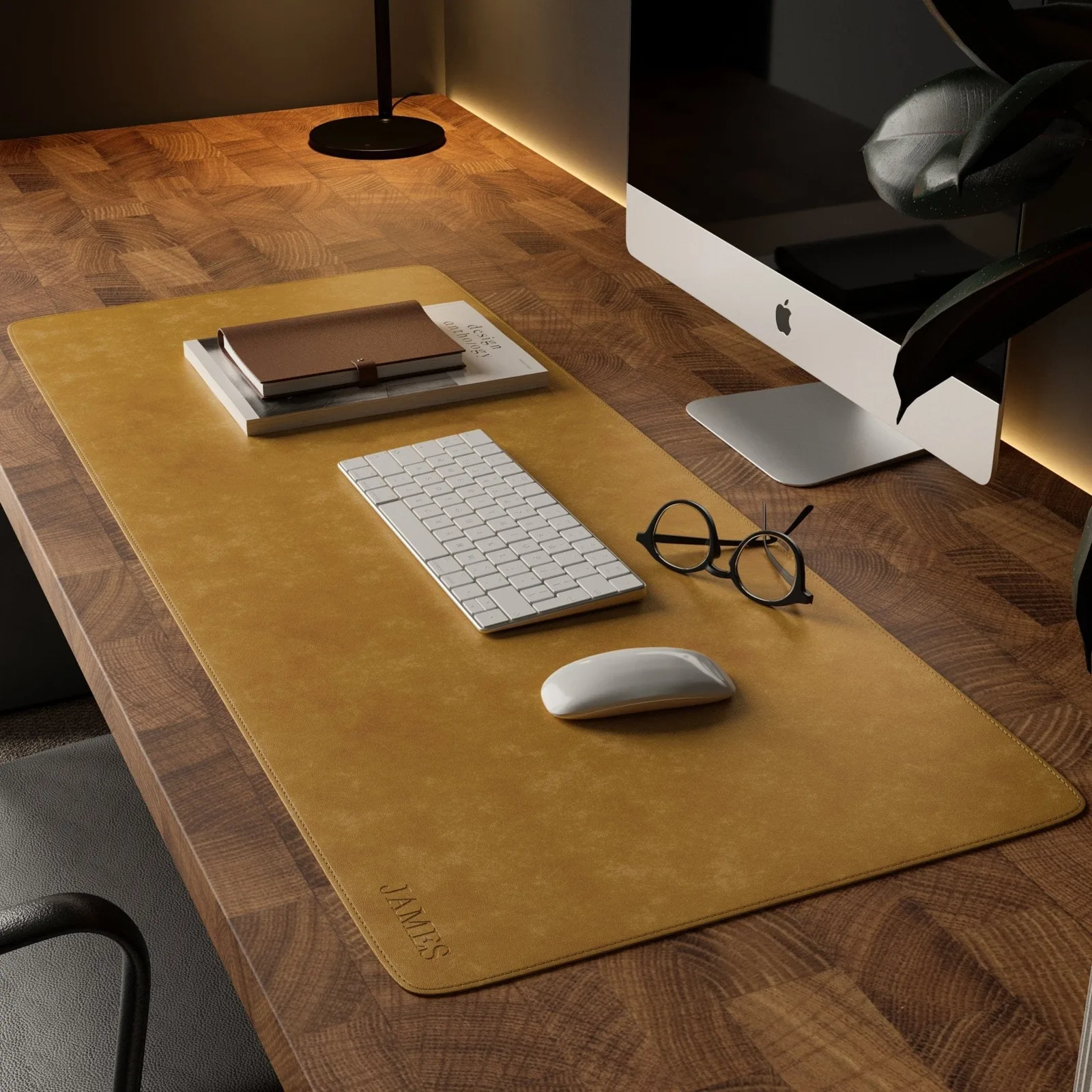 Mustard St. George leather desk mat on a walnut desk under a white keyboard, mouse, and glasses